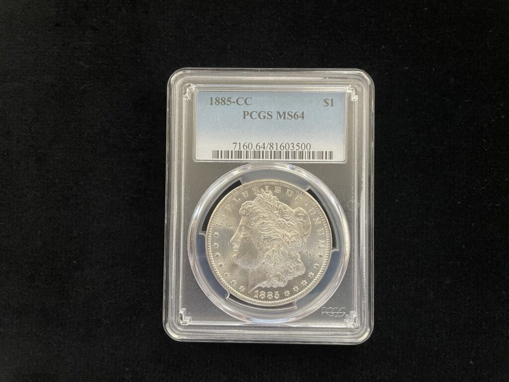 A closeup look a coin in a case with tags 1885-cc