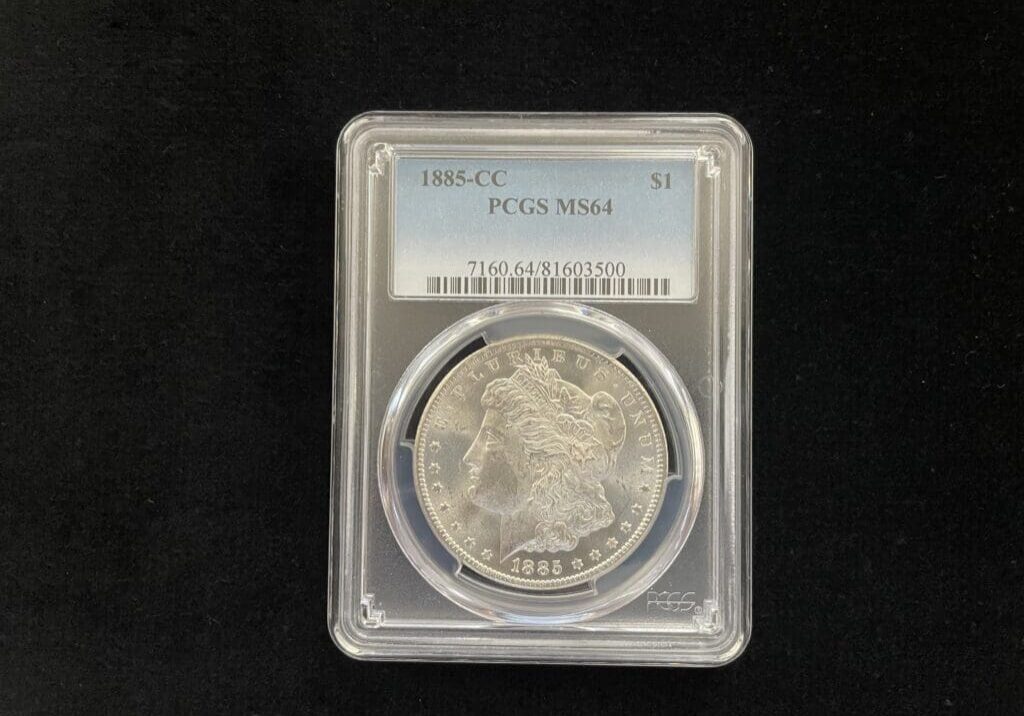 A closeup look a coin in a case with tags 1885-cc